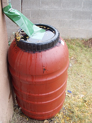 Rain Barrel overflowing with rain water