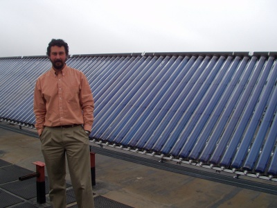 Professor Andrea Mammoli and solar collectors on the UNM Mechanical Engineering Building Professor Andrea Mammoli and solar collectors on the UNM Mechanical Engineering Building