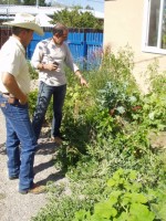 Santa Fe County Extension Agent touring Bob's garden